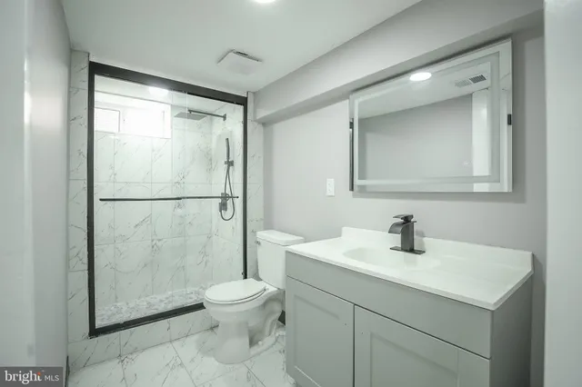 a view of a storage & utility room with two washing machine