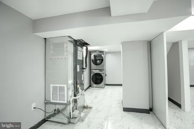 a room with a washing machine and a rug