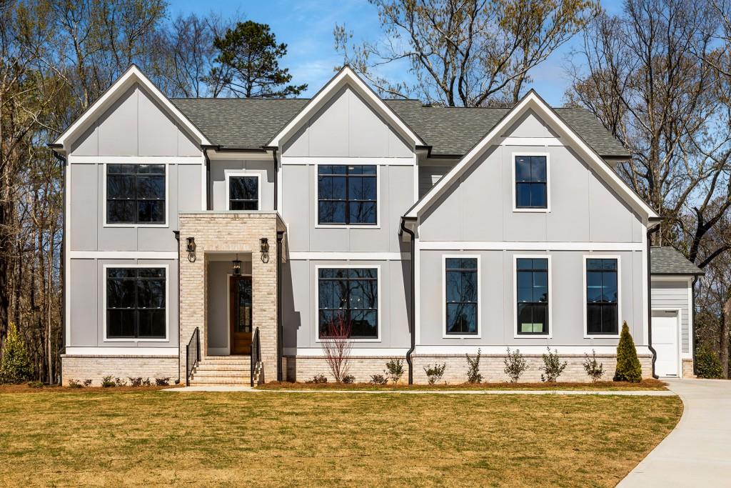 a front view of a house with a yard balcony and seating space