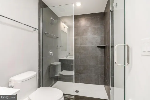 a bathroom with a toilet and a shower