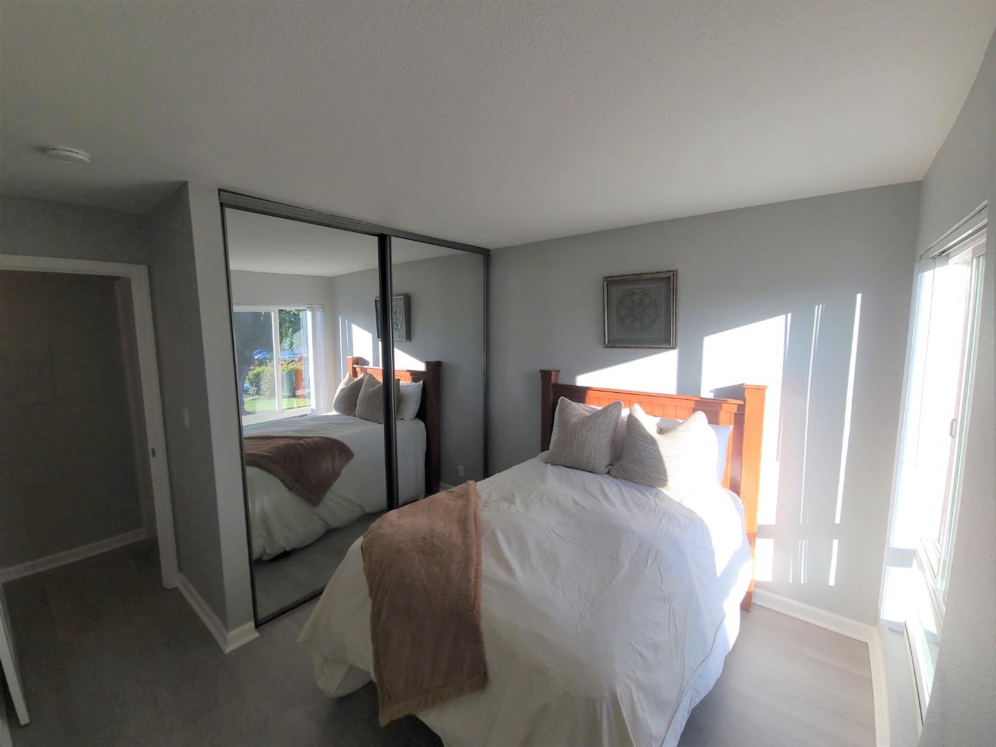 424 Dempsey Road, Unit 227 Milpitas, CA 95035 - Photo 14 of 24 a bedroom with two beds and a large mirror