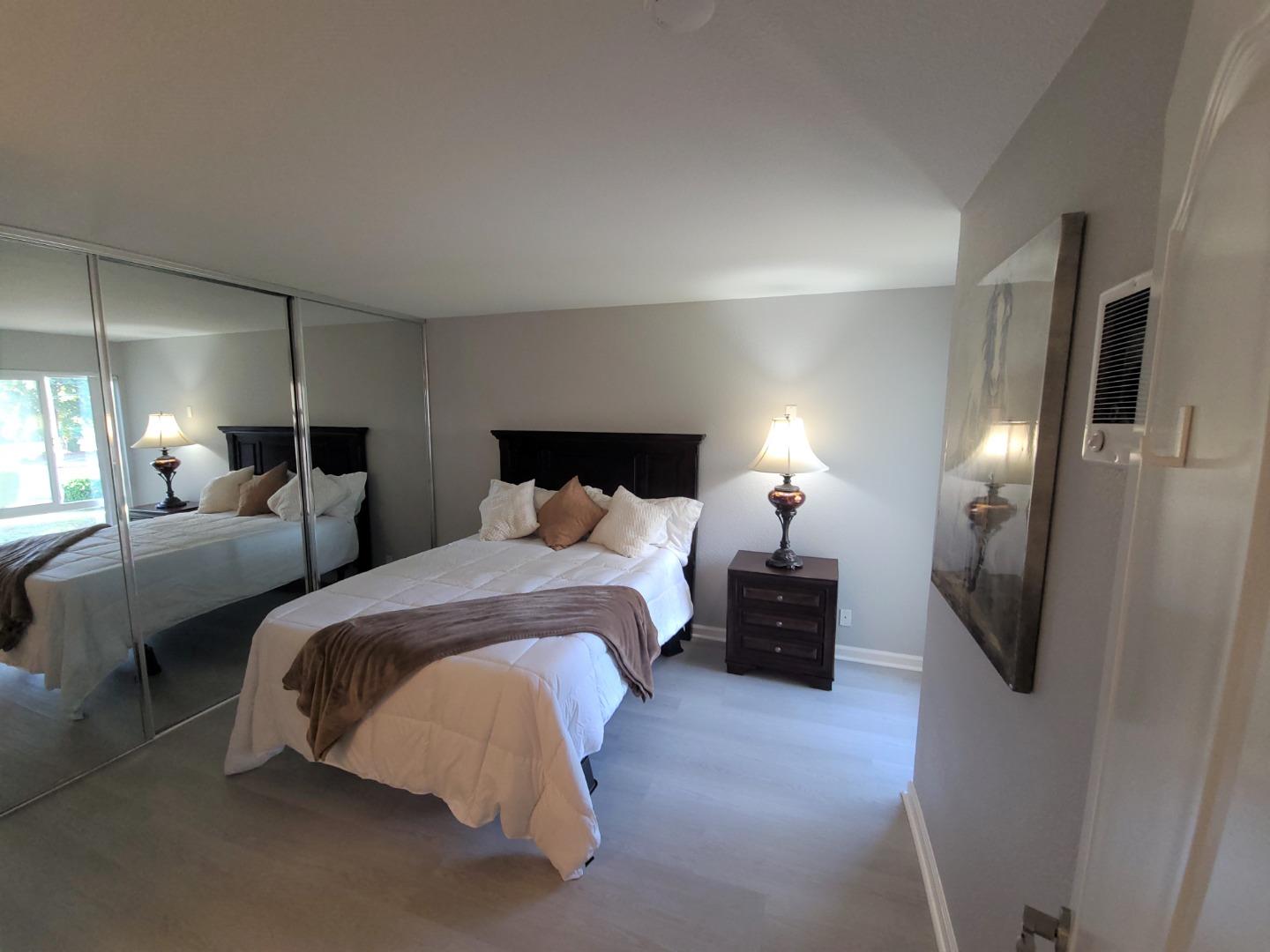 424 Dempsey Road, Unit 227 Milpitas, CA 95035 - Photo 15 of 24 a spacious bedroom with a bed and a lamp