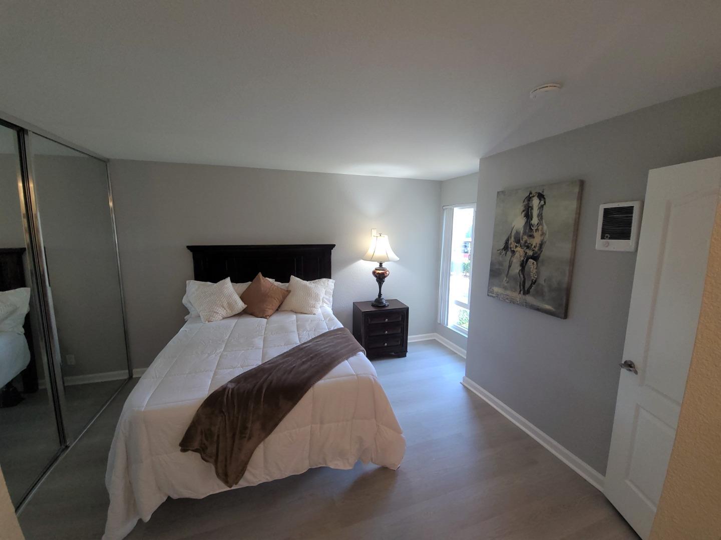 424 Dempsey Road, Unit 227 Milpitas, CA 95035 - Photo 16 of 24 a bed room with a bed and a night stand