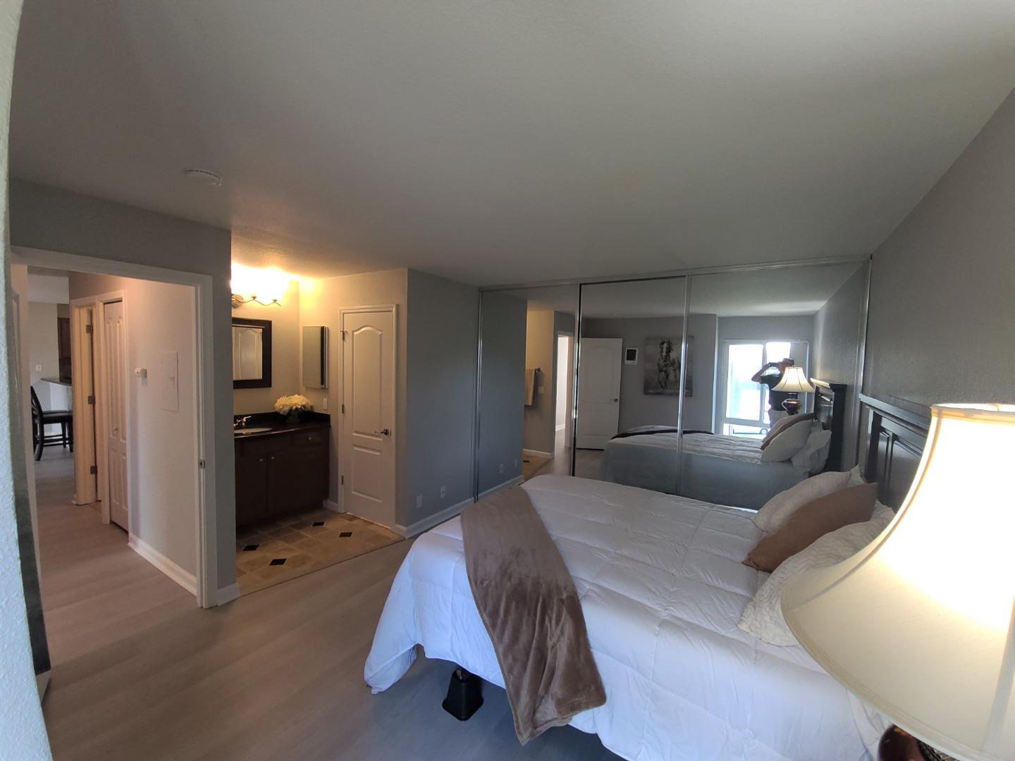 424 Dempsey Road, Unit 227 Milpitas, CA 95035 - Photo 17 of 24 a large bedroom with a bed and a view of bathroom