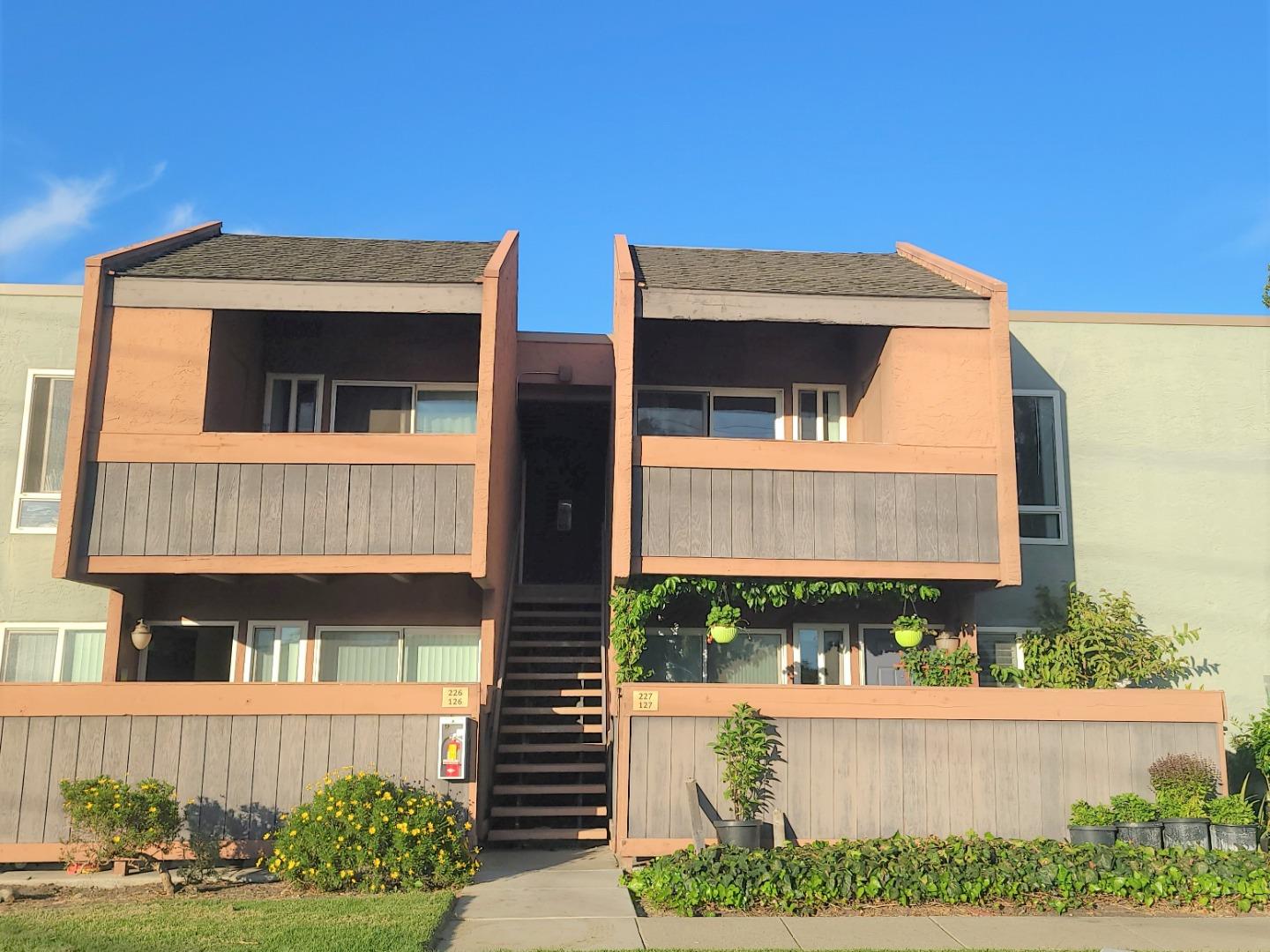 424 Dempsey Road, Unit 227 Milpitas, CA 95035 - Photo 2 of 24 a front view of a house with a yard