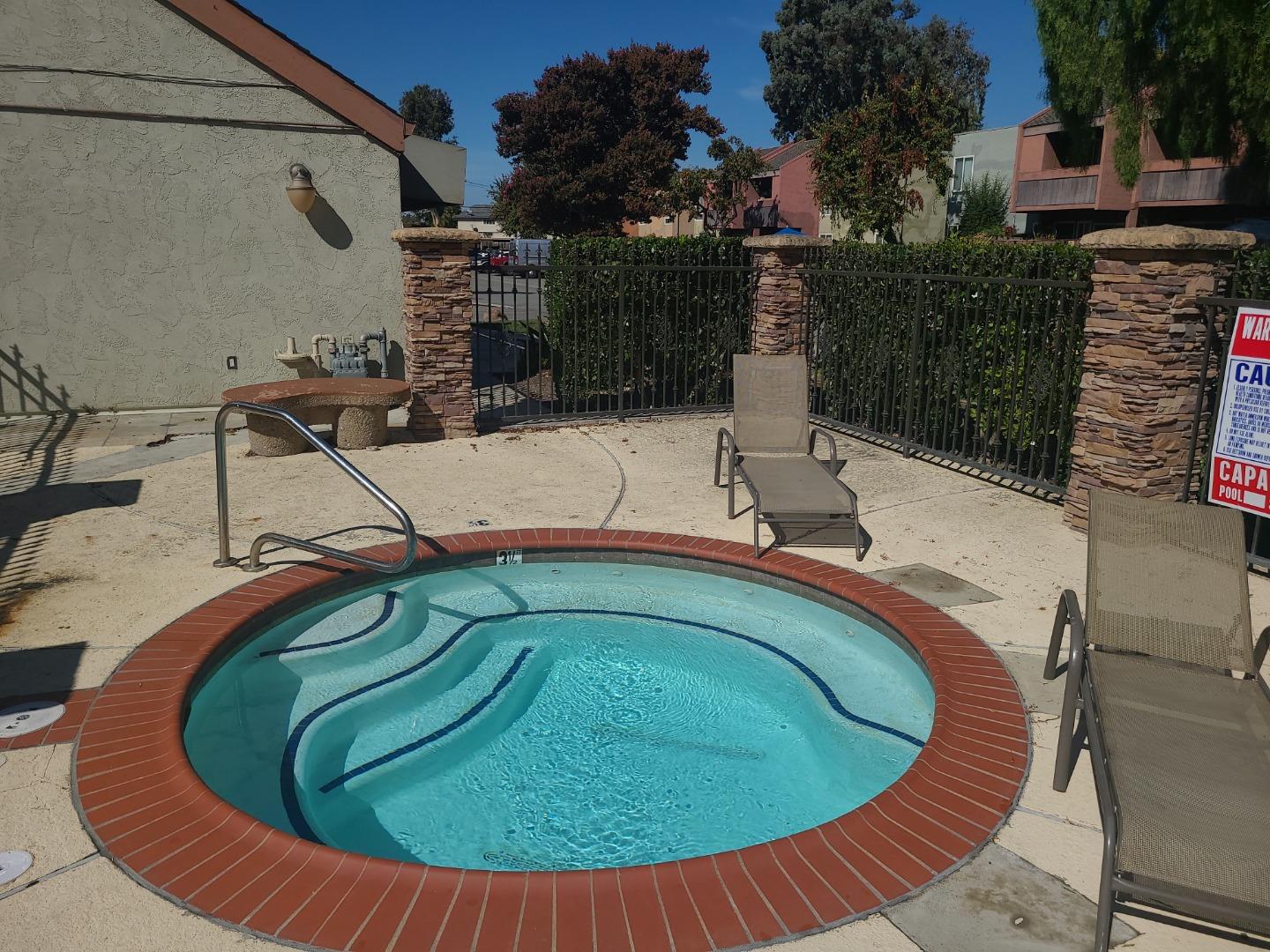424 Dempsey Road, Unit 227 Milpitas, CA 95035 - Photo 23 of 24 a small pool with a table and chairs
