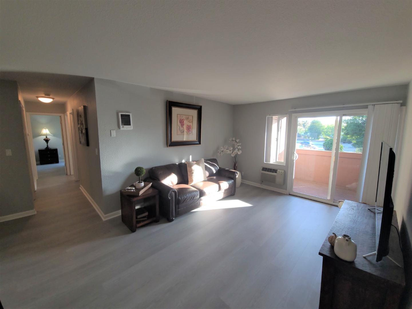 424 Dempsey Road, Unit 227 Milpitas, CA 95035 - Photo 4 of 24 a living room with furniture and large windows