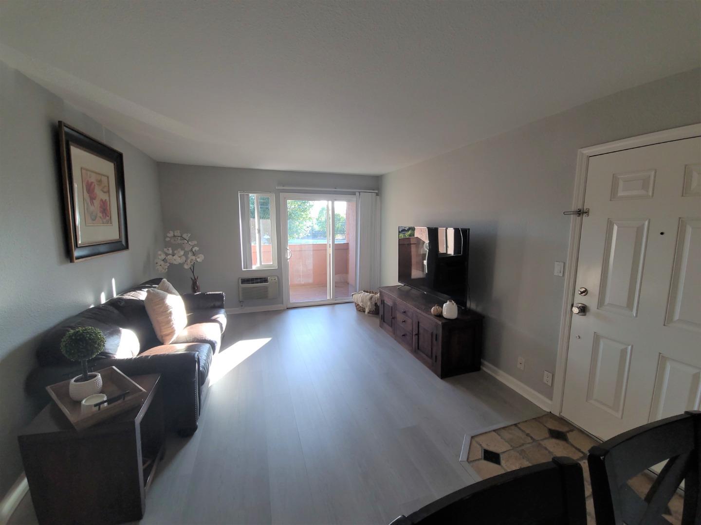 424 Dempsey Road, Unit 227 Milpitas, CA 95035 - Photo 5 of 24 a living room with furniture and wooden floor