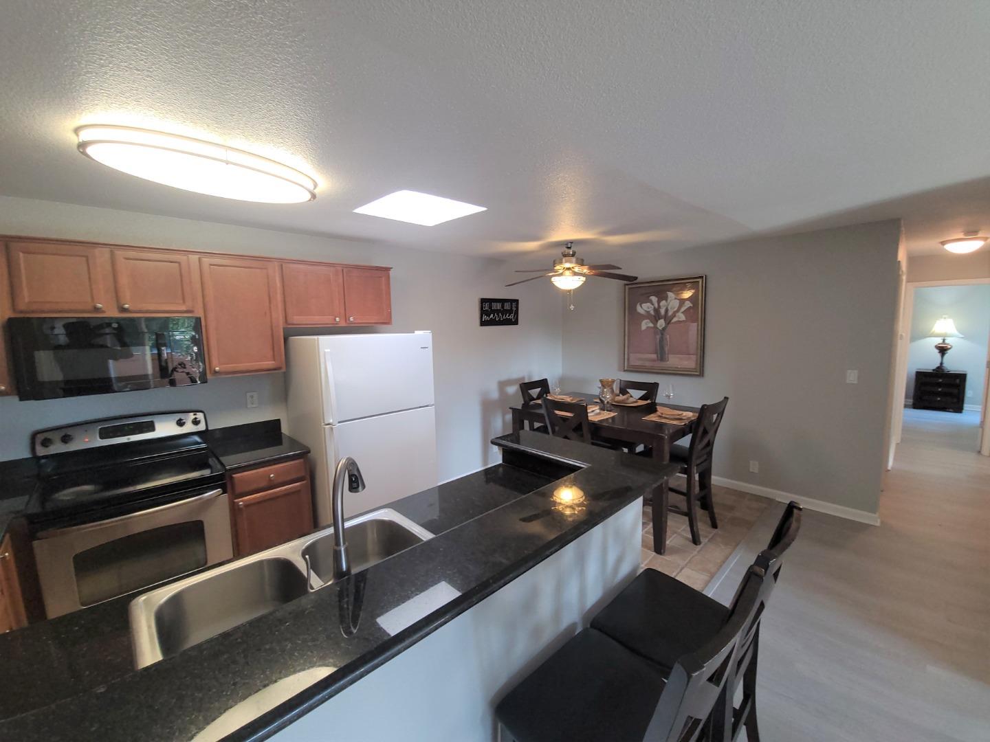 424 Dempsey Road, Unit 227 Milpitas, CA 95035 - Photo 7 of 24 a kitchen with kitchen island a stove and a refrigerator