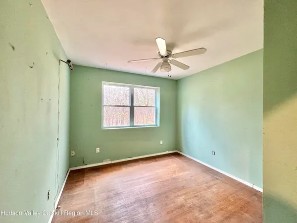 a view of a room with wooden floor and bathroom