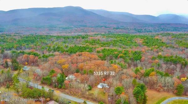 a view of a lush green hillside and a building