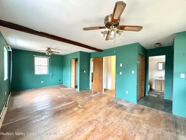 a view of a hallway with a room