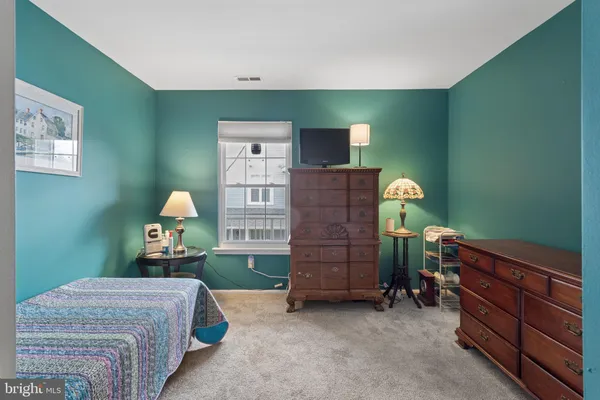 a room with stairs and a dresser