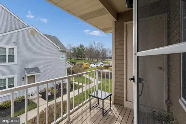 a bedroom with a bed a dresser and next to a window