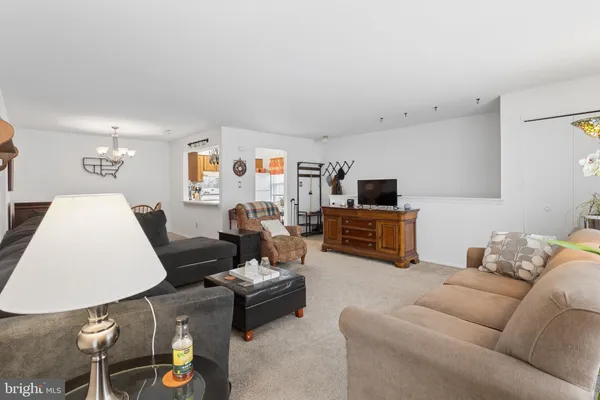 a view of a dining room with furniture and chandelier