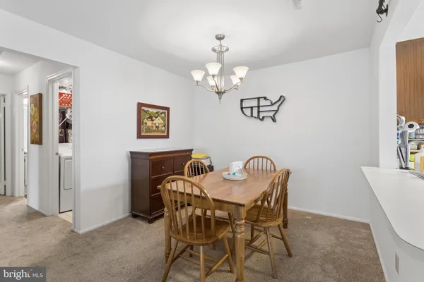 a view of a dining room with furniture and chandelier