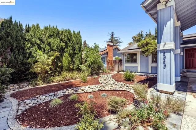 a view of a house with a yard and sitting area