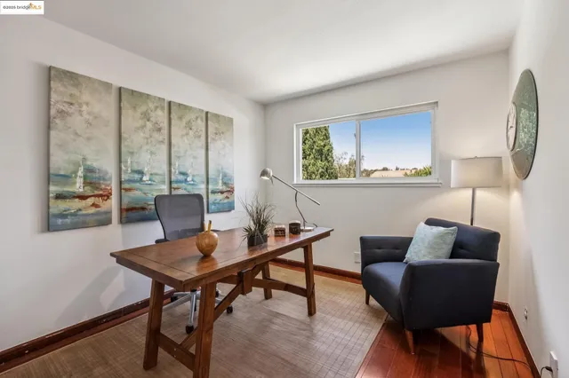 a spacious bedroom with a bed and a chandelier