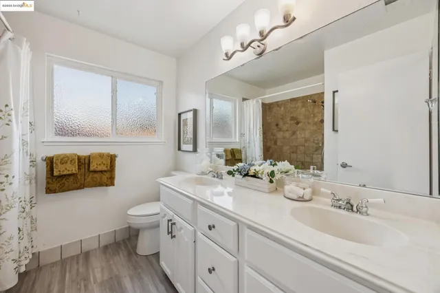 a bathroom with a double vanity sink and a mirror