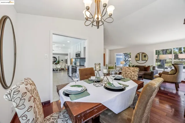 a living room with lots of white furniture and chandelier