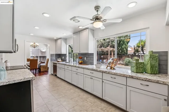 a living room with furniture a rug and white walls