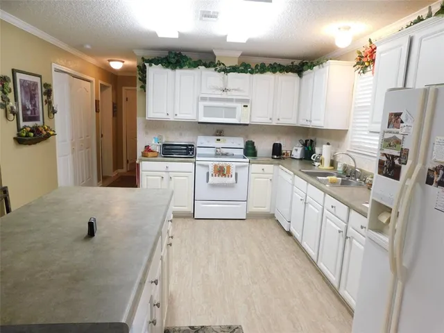 a kitchen with stainless steel appliances granite countertop a refrigerator sink and cabinets