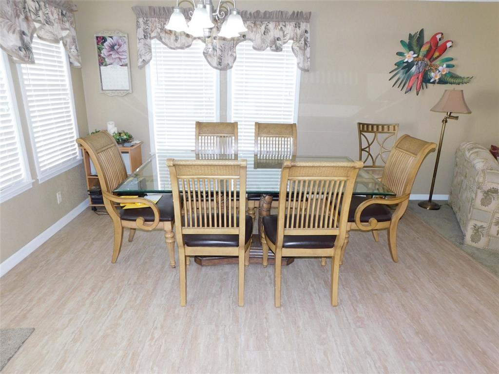 11739 Southwest Lemon Avenue Arcadia, FL 34269 - Photo 23 of 52 a view of a dining room with furniture and wooden floor