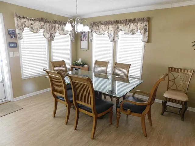 a view of a dining room with furniture and windows