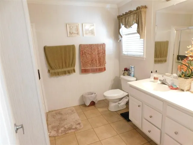 a spacious bathroom with a toilet sink and mirror