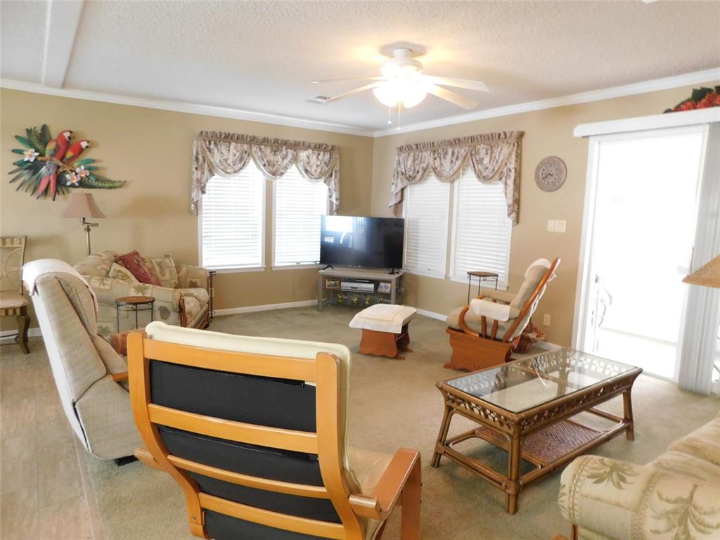 11739 Southwest Lemon Avenue Arcadia, FL 34269 - Photo 9 of 52 a living room with furniture a flat screen tv and a large window