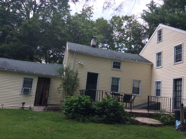a view of a house with a yard and a garden