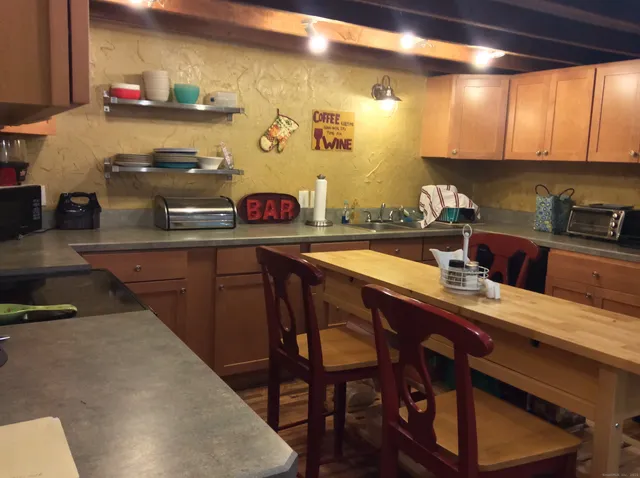 a kitchen with a sink a stove and chairs