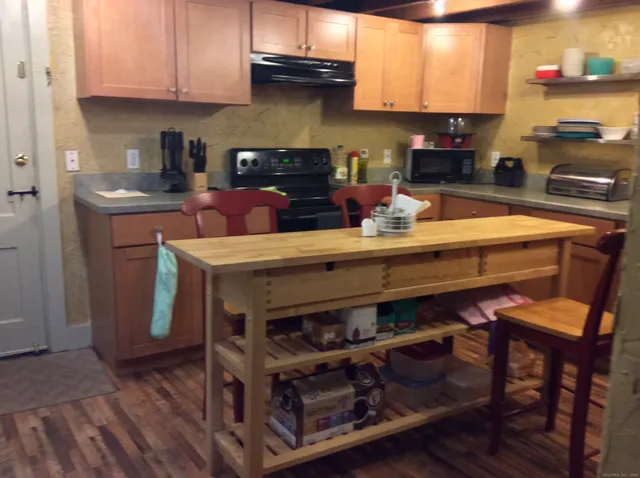 a kitchen with a wooden table chairs and cabinets