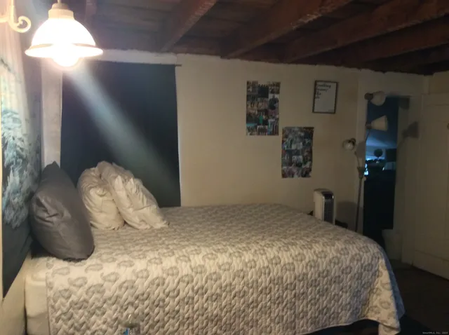 a bedroom with a bed and a lamp