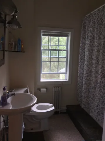 a bathroom with a sink a toilet and tub