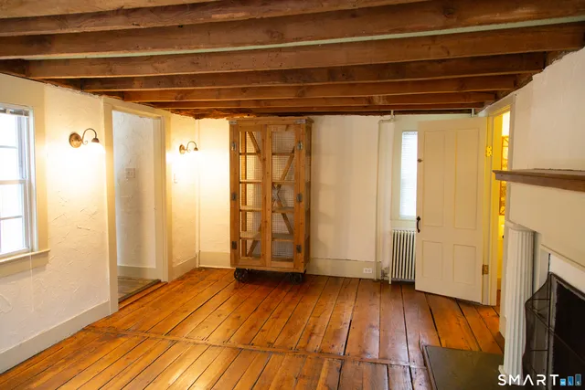 a view of a room with wooden floors and brick walls