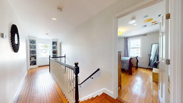 a view of a hallway view with wooden floor and furniture