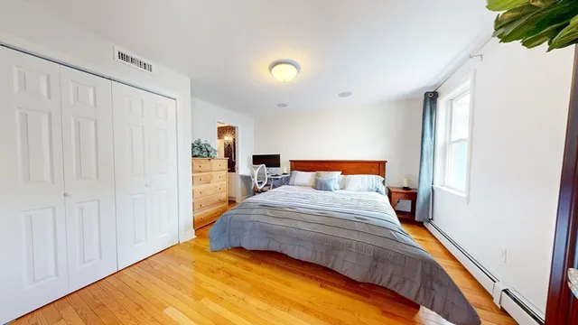 a bedroom with a bed and a window