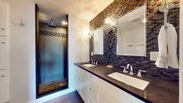 a bathroom with a double vanity sink and a mirror