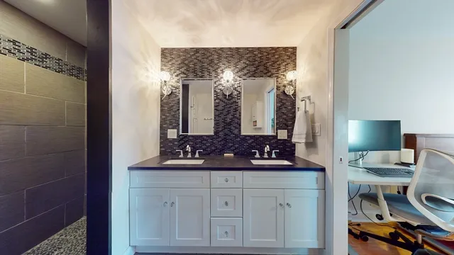 a bathroom with a double vanity sink and a mirror