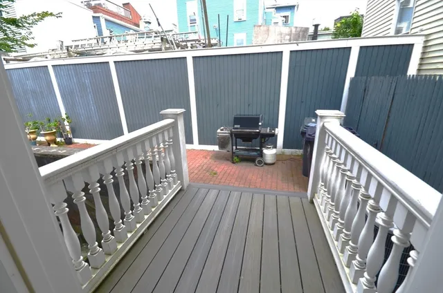 a balcony with view of car parked