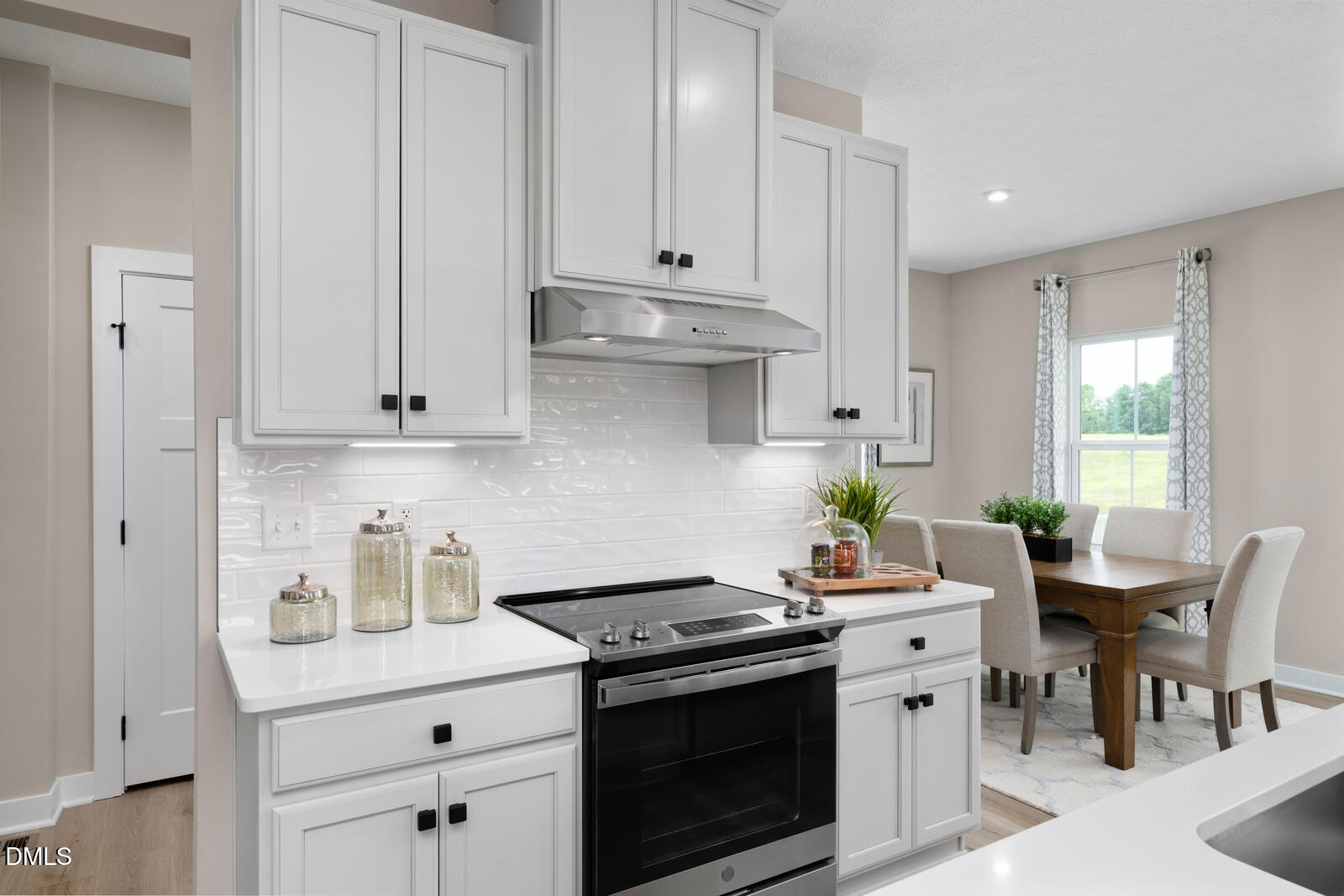 574 Freedom Trail Drive Willow Spring, NC 27592 - Photo 4 of 43 a kitchen with stainless steel appliances a white stove top oven and white cabinets