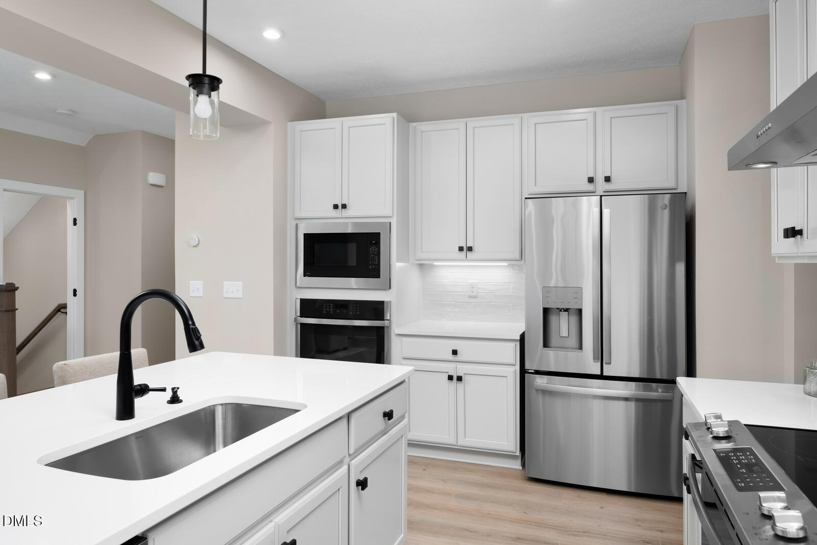 574 Freedom Trail Drive Willow Spring, NC 27592 - Photo 5 of 43 a kitchen with stainless steel appliances a refrigerator sink and white cabinets