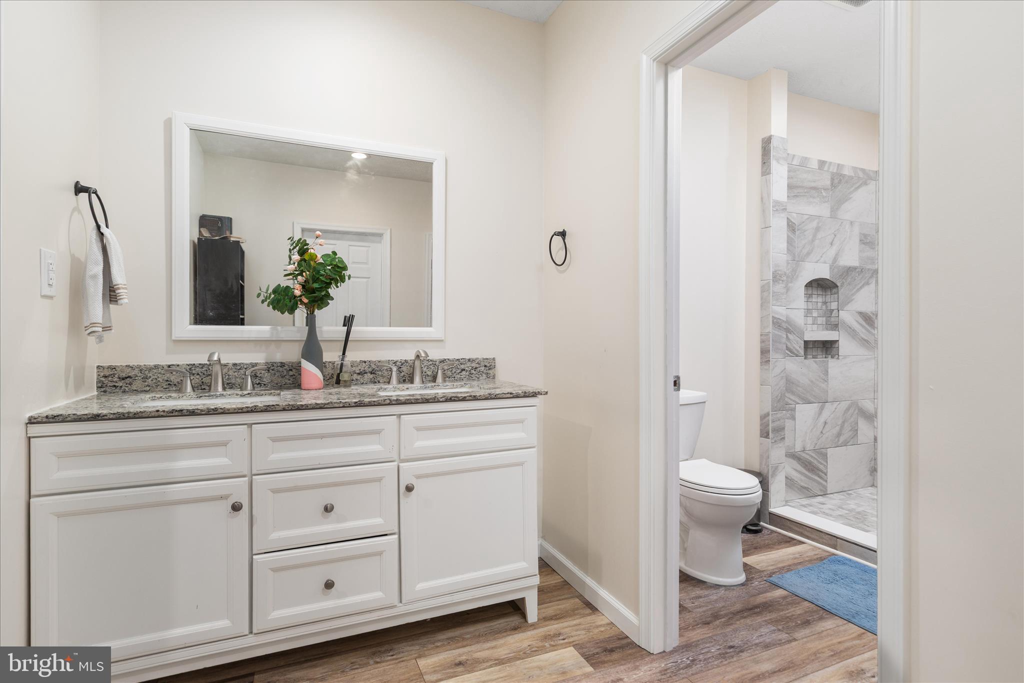 23 Cherrywood Road Front Royal, VA 22630 - Photo 15 of 33 a bathroom with a granite countertop sink a toilet and a mirror