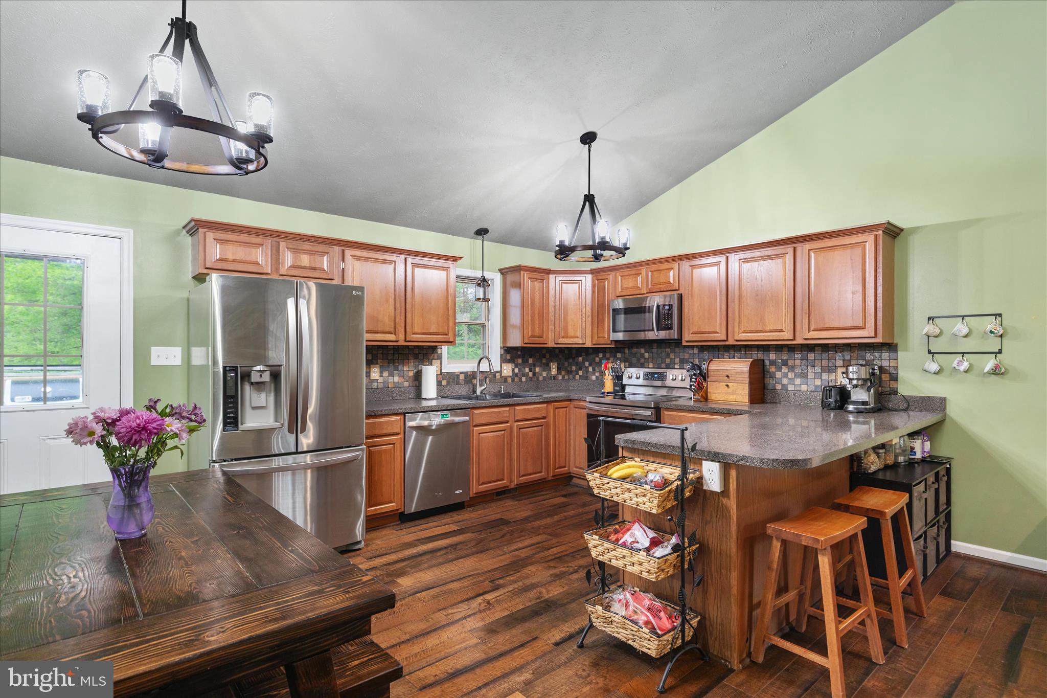 23 Cherrywood Road Front Royal, VA 22630 - Photo 5 of 33 a kitchen with stainless steel appliances granite countertop a refrigerator a sink dishwasher a dining table and chairs with wooden floor