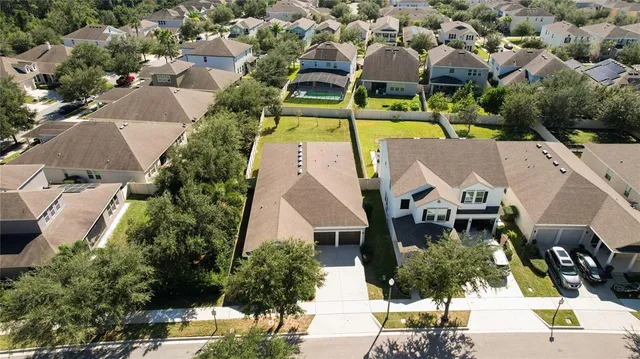 an aerial view of a house with yard