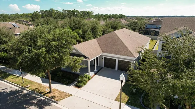 an aerial view of residential house with outdoor space and parking