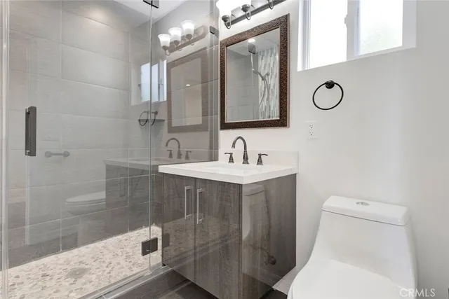 a bathroom with a sink mirror vanity and toilet