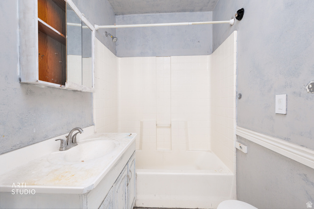 330 West 600th Street South Provo, UT 84601 - Photo 19 of 26 Bathroom featuring an integrated vanity sink with a two-handle faucet, a medicine cabinet with mirrored doors, and a shower-tub combination with a white surround