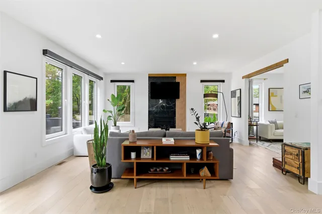 a living room with furniture and large windows